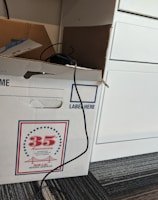 Professional movers carefully packing a client's belongings in a modern apartment.